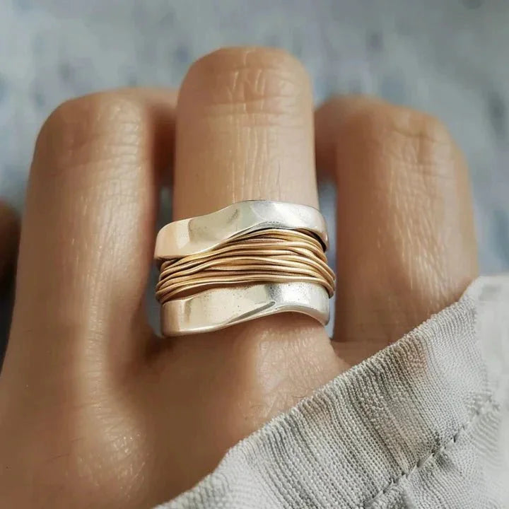 Elegant women's dual-tone wavy silver ring with intricate wire-wrap detail, a stylish fashion accessory.