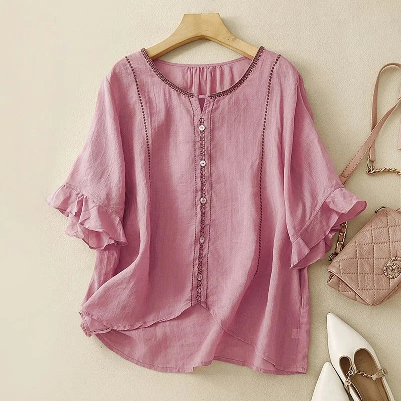 Detailed embroidered women's blouse. Features a V-neck, 3/4 ruffled sleeves, offering a sophisticated casual look.