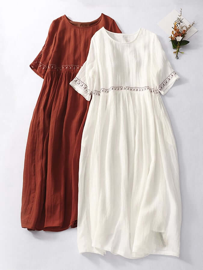 White embroidered loose women's dress, a versatile elegant day dress for summer comfort.
