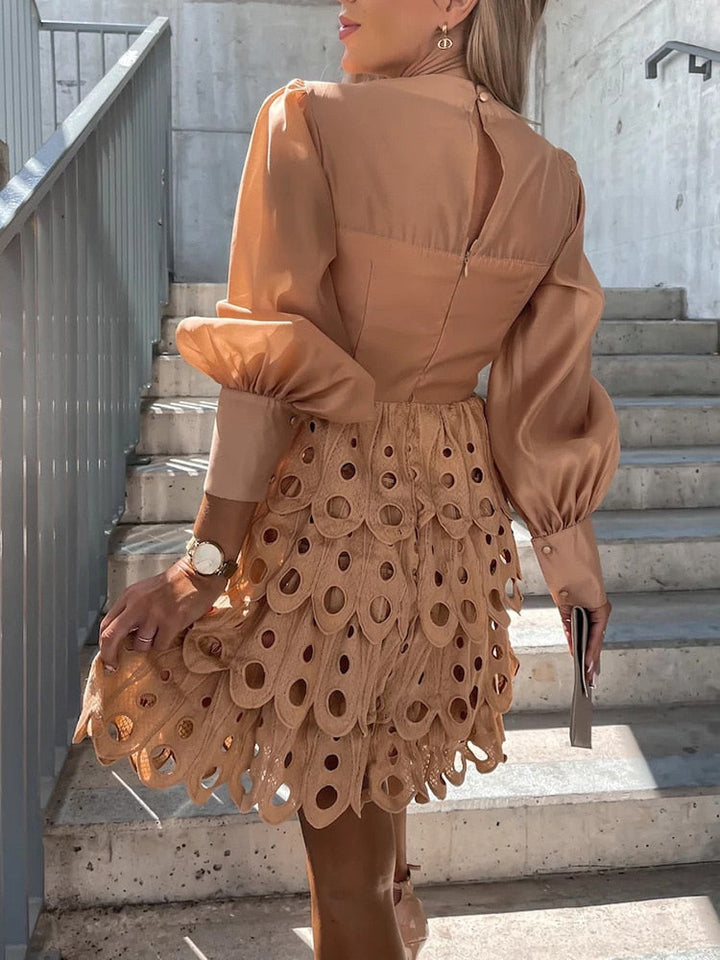 Chic women's embroidered mini dress with sheer sleeves & cutwork, an elegant choice for evening wear.
