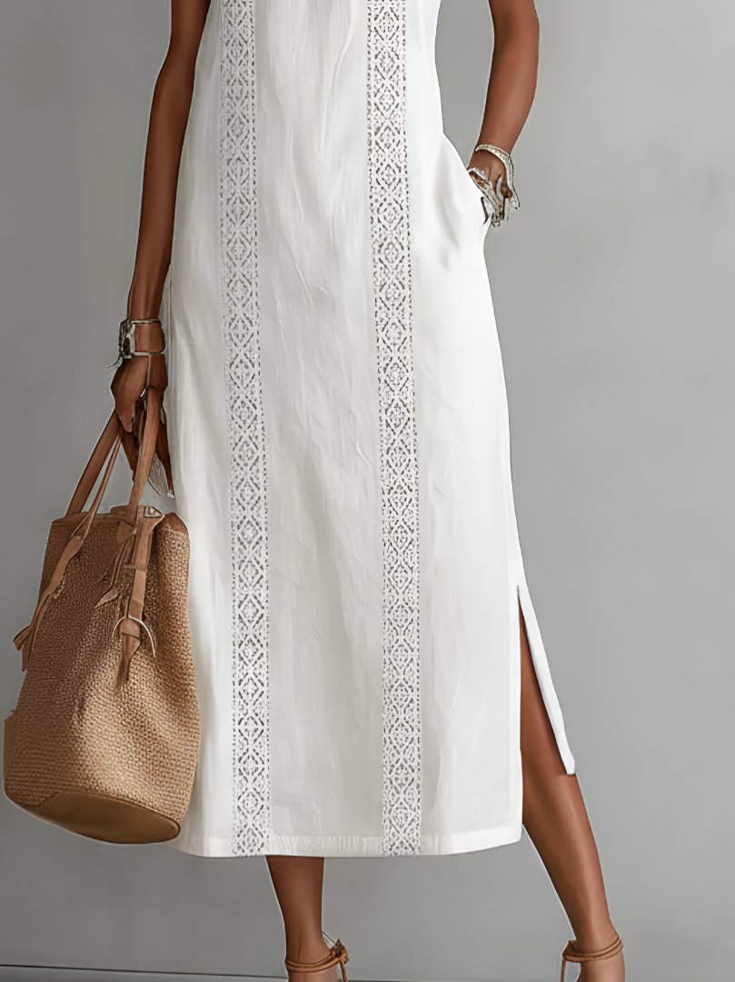 Sleeveless embroidered women's dress, midi length, featuring elegant design for day or evening events.