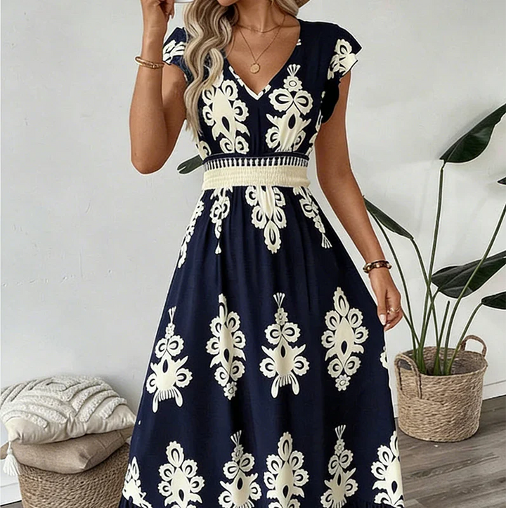 Embroidered bodice detail of an elegant women's V-neck summer midi dress, highlighting exquisite design.