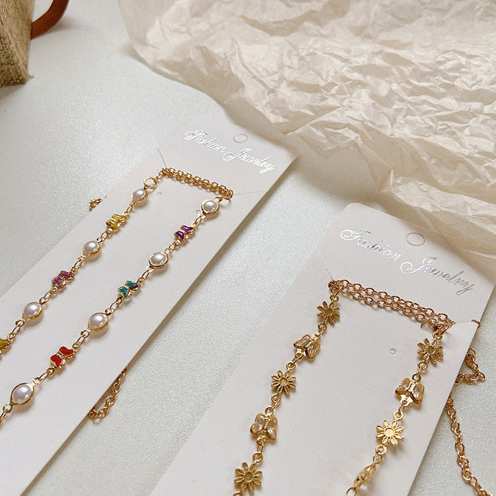 Fashionable women's eyeglass holder, a colorful crystal & pearl chain accessory for elegant eyewear styling.