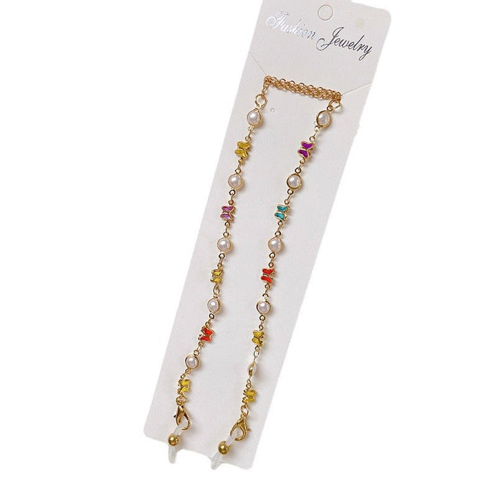 Woman wearing a chic eyeglass chain with colorful crystals & pearls, a functional & fashionable eyewear accessory.