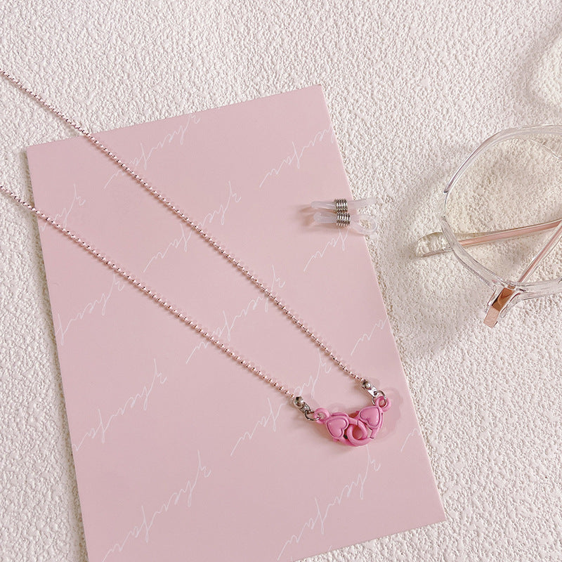 Stylish women's glasses holder chain featuring a charming heart pendant, ideal eyewear accessory for convenience.