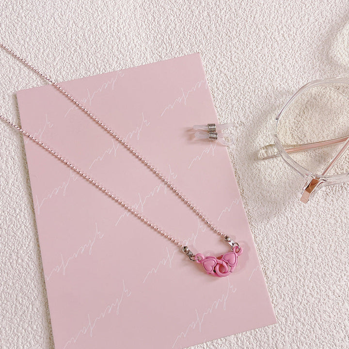 Stylish women's glasses holder chain featuring a charming heart pendant, ideal eyewear accessory for convenience.