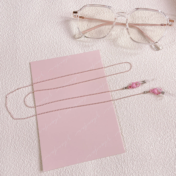 Fashionable women's eyeglass chain with a heart pendant, a great gift idea for stylish eyewear security. Pink available.