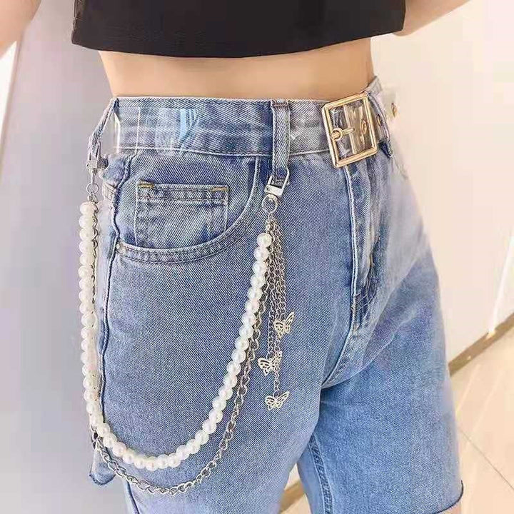 Trendy women's pearl and chain belt with a clear butterfly charm, a stylish statement accessory for any outfit.
