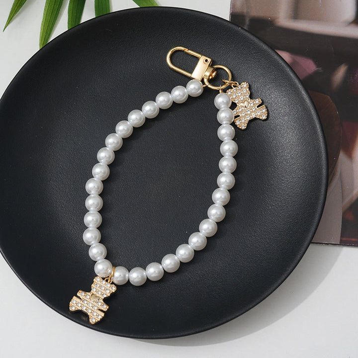 Fashionable women's faux pearl bracelet with a chic rhinestone bow, ideal for elegant style.