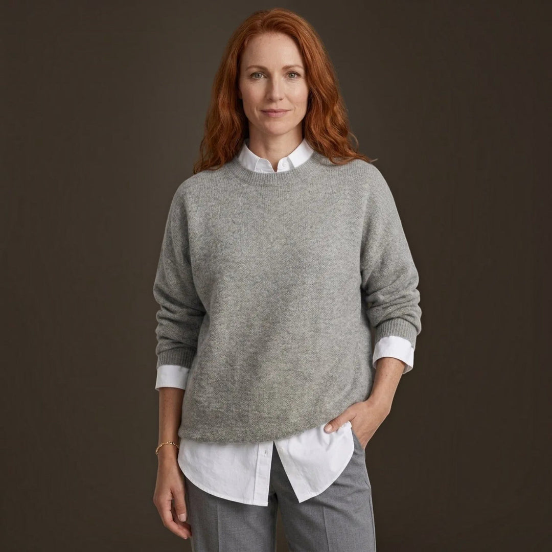 Elegant women's fine knit pullover sweater in a warm, comfortable fabric, perfect for fall and winter fashion.