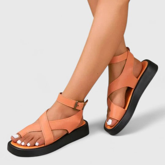 Practical & elegant women's flat sandals, offering comfortable support and stylish appeal for summer days.