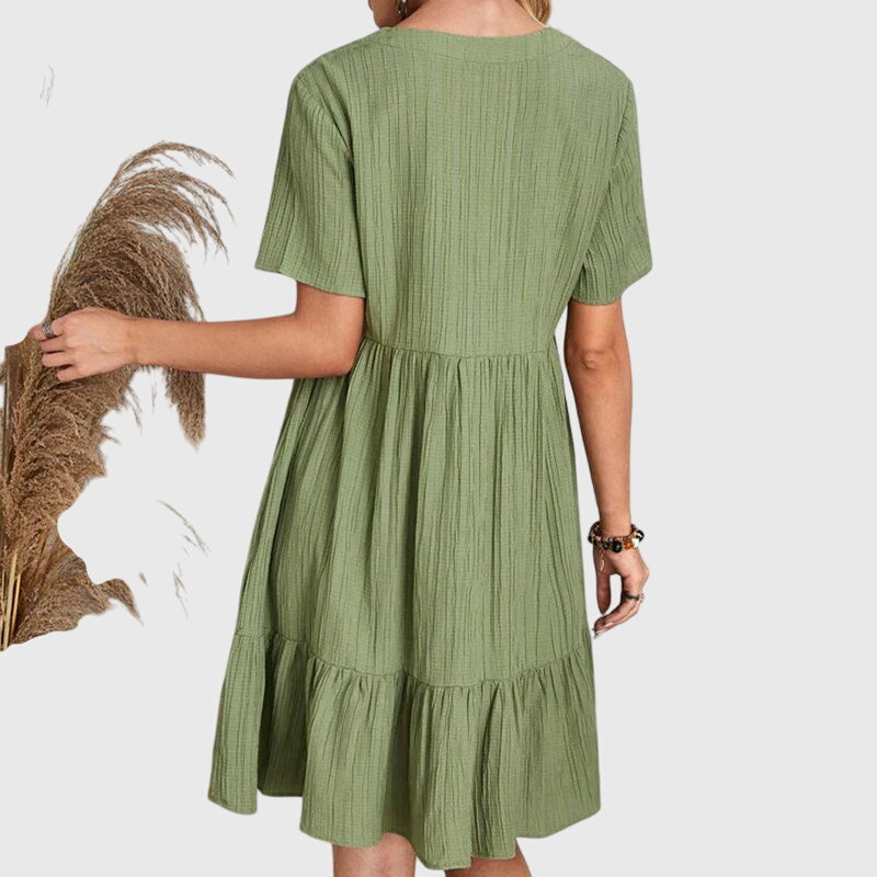 Stylish women's elegant dress, flattering cut in a chic summer style. Versatile for day.