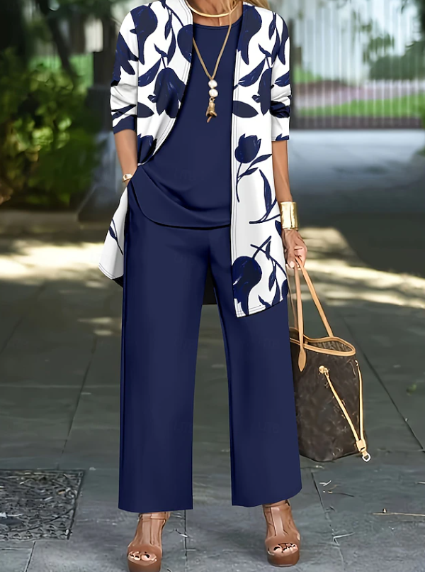 Matching women's floral outfit set. Elegant short-sleeve top, wide-leg trousers, and a stylish open jacket.
