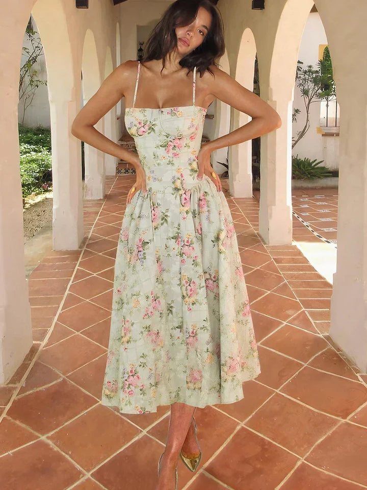 Elegant women's floral A-line midi dress, perfect for wedding guests, with delicate straps and a flowing skirt.