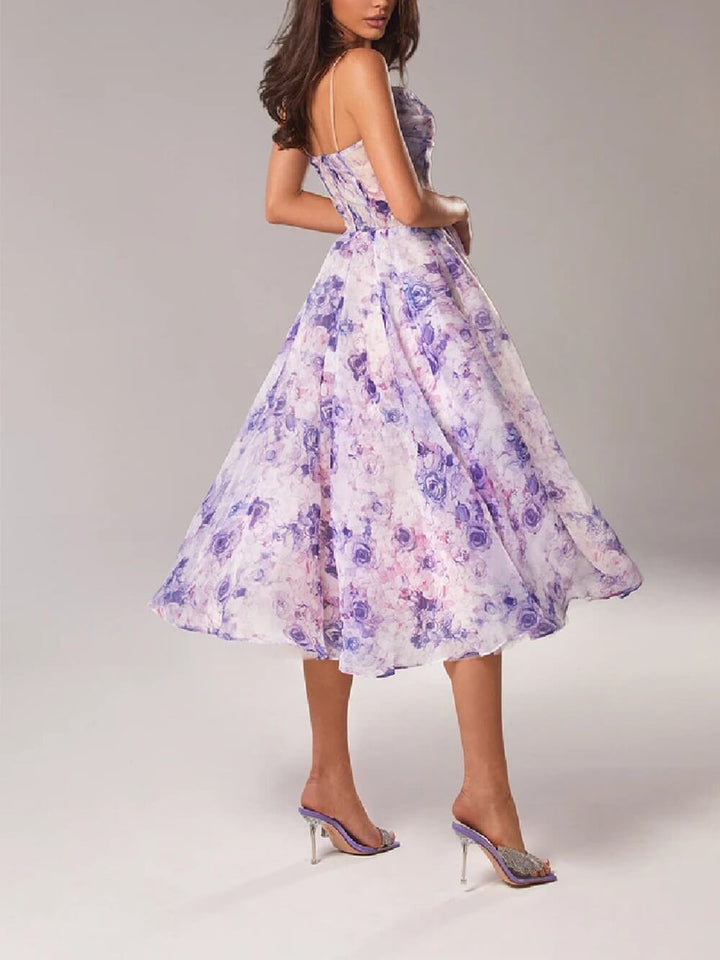 Vibrant floral print A-line midi dress for women, featuring delicate spaghetti straps, perfect for a romantic summer look.