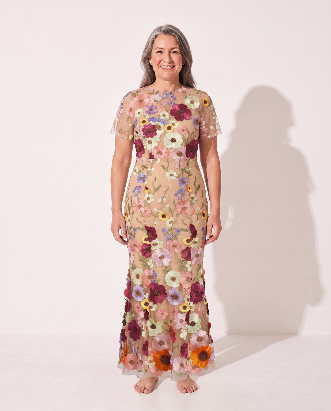 Full view of the women's floral appliqué midi dress, showcasing its elegant silhouette and sheer sleeve detail.