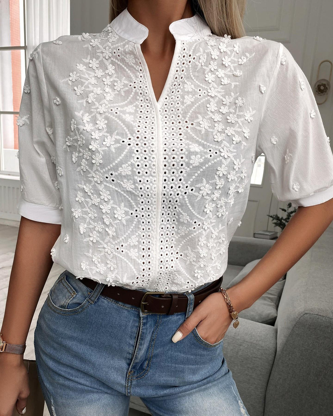 Stylish women's blouse with intricate floral embroidery, an elegant choice for any occasion.