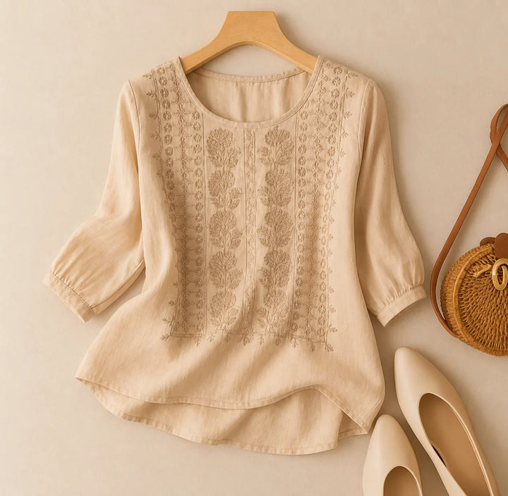 Casual chic women's blouse with floral embroidery, puff sleeves, round neck & relaxed fit. Ideal for spring.