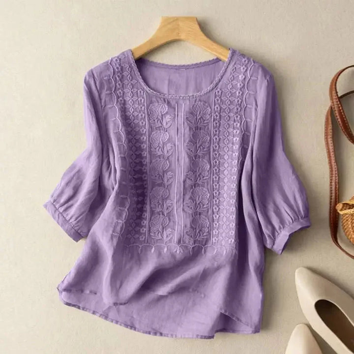 Floral embroidered women's top with stylish puff sleeves & relaxed design. Great for elegant spring/summer outfits.