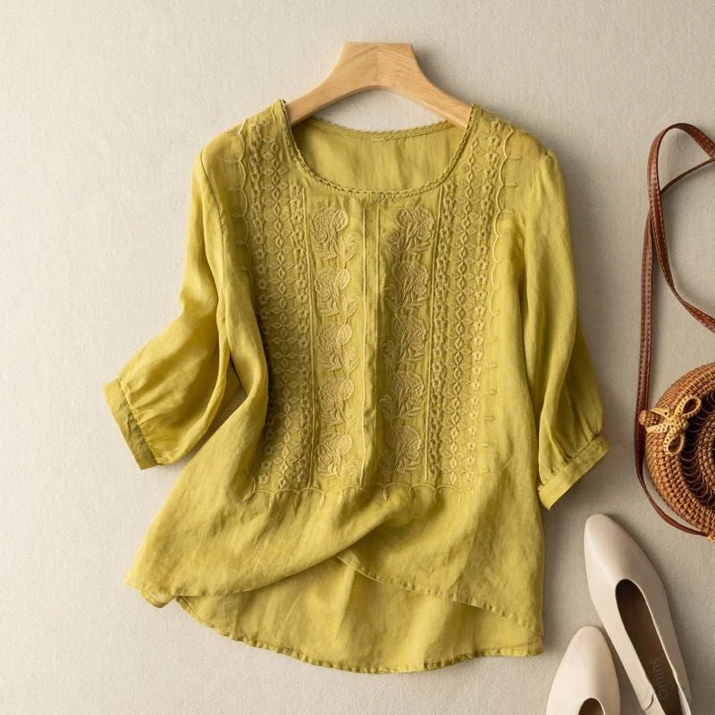Relaxed women's floral embroidered blouse, featuring puff sleeves & round neck, ideal for casual chic summer style.