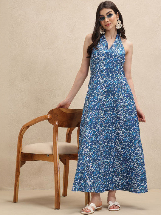 Vibrant floral printed halterneck maxi dress for women. Ideal elegant flowing summer, vacation, or beach party wear.