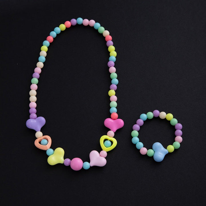 Detailed elegant floral bracelet with pastel pearls, part of women's jewelry set. Fashionable accessory.