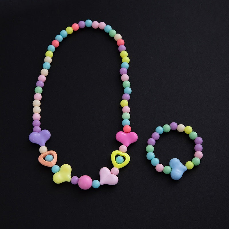 Delicate floral motif detail on elegant women's jewelry set, featuring pastel pearls. Exquisite design.