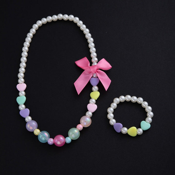 Beautiful women's floral jewelry set: elegant necklace & matching bracelet with soft pastel pearls.