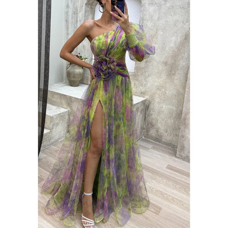 Elegant women's maxi evening gown in a floral print, featuring a stylish one-shoulder, sheer detail, and slit.