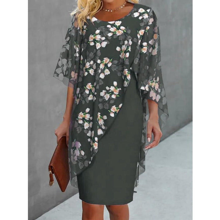 Stylish women's midi dress featuring a vibrant floral print and sophisticated cape, suitable for casual or party.