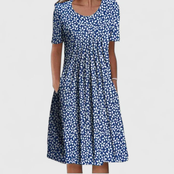 Sophisticated women's polka dot midi dress, enhanced with charming floral accents for a spring look.