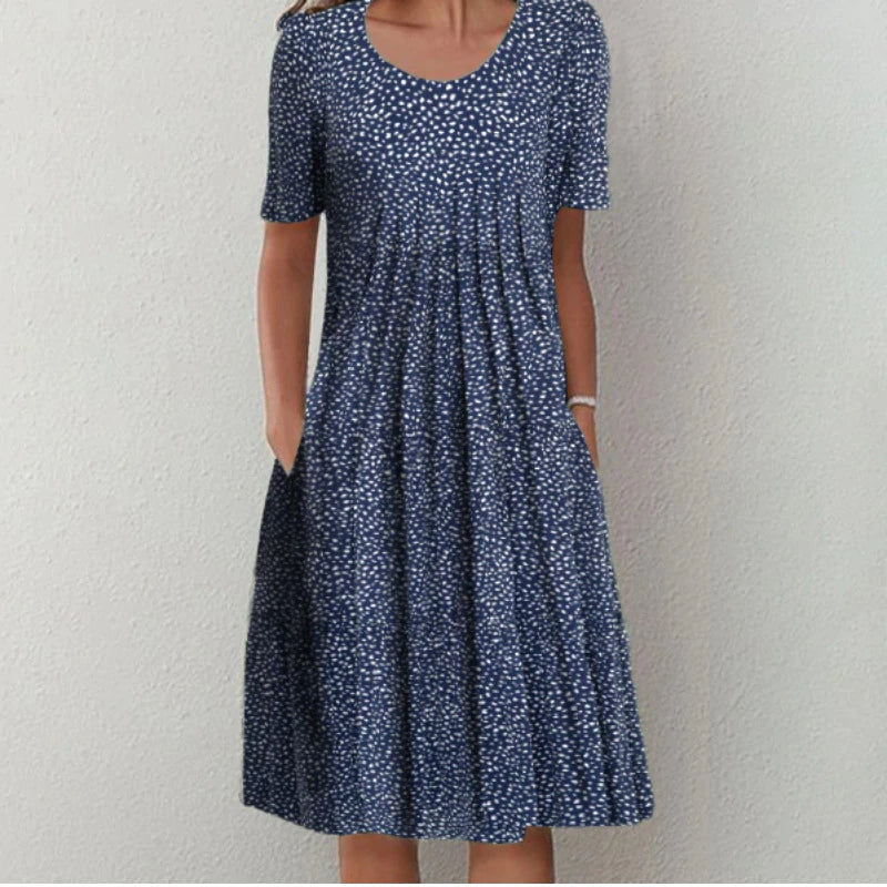Women's elegant midi dress in a flowing fabric, showcasing a beautiful floral and polka dot design.