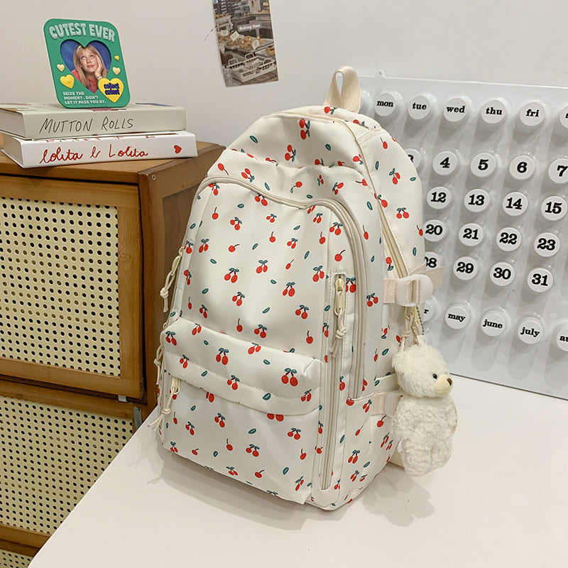 Versatile women's floral print backpack, ideal as a school daypack or stylish travel bag. Durable water-resistant fabric.