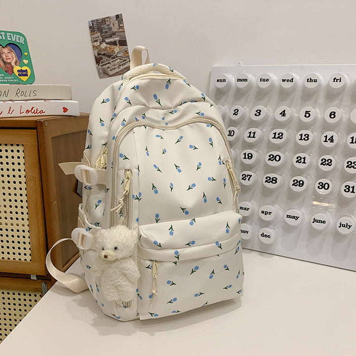 Front view of an elegant women's floral print school backpack, featuring vibrant patterns & sturdy construction.