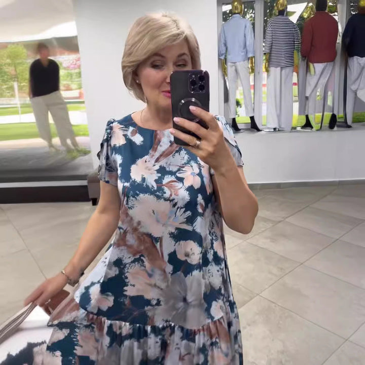Flowy floral tiered maxi dress for women. Chic summer fashion, ideal for casual or elegant events.