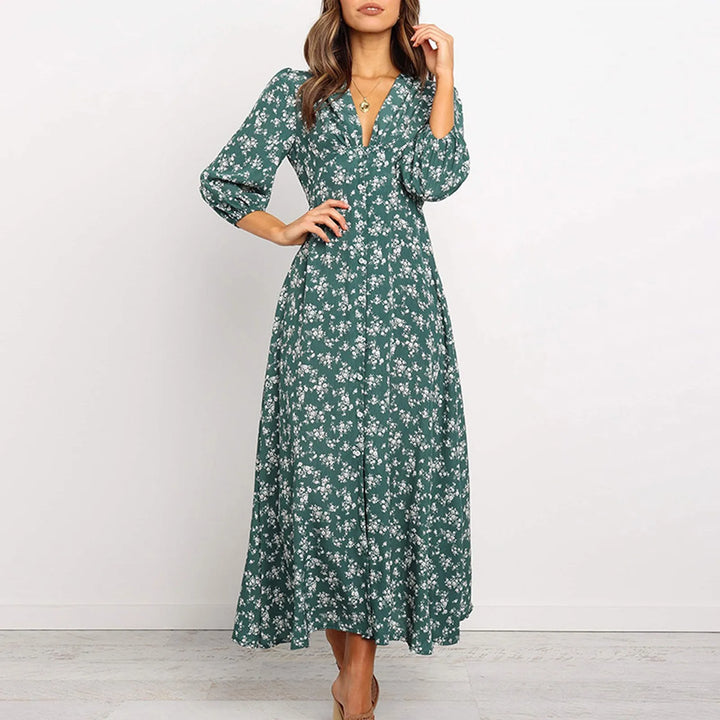 Navy floral V-neck maxi dress for women. Flowing elegant summer style, versatile for casual or dressy occasions.