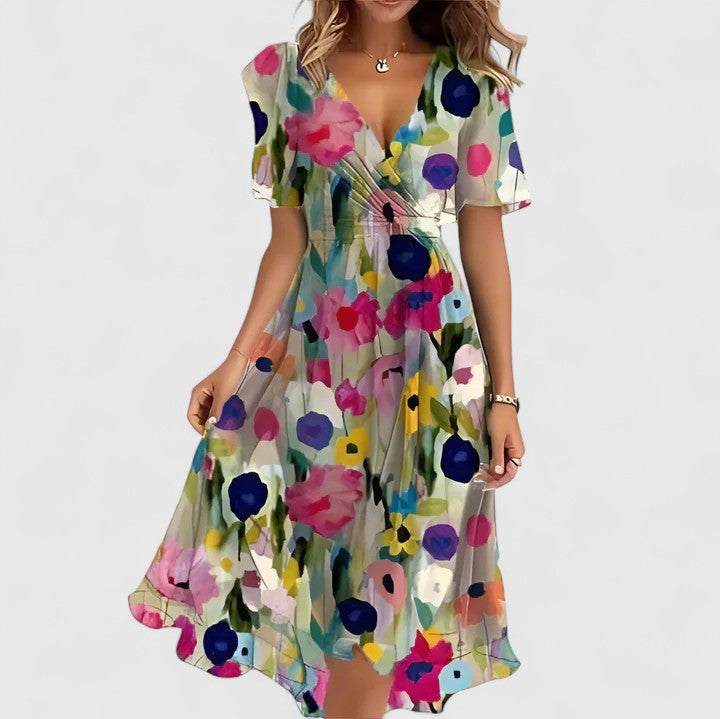 Close-up: Vibrant floral print on an elegant V-neck women's midi dress, perfect for summer. Flowy design.