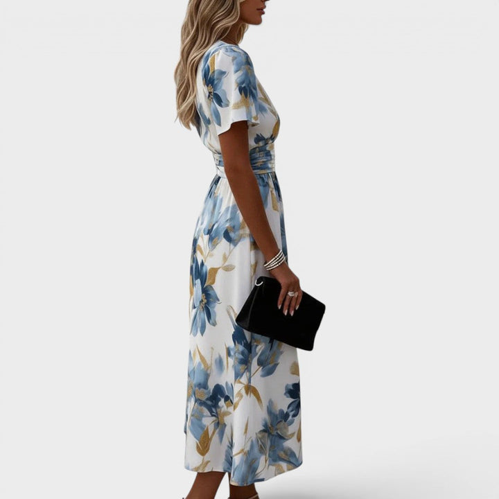 Close-up of a women's floral midi wrap dress, showcasing vibrant flower print and soft fabric texture for summer.