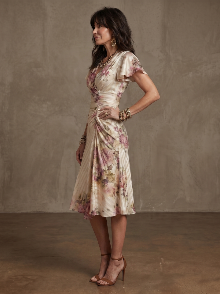 Vibrant floral wrap midi dress with flutter sleeves, ideal as an elegant summer day dress or party wear.