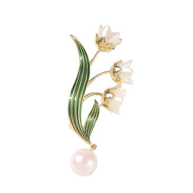 Sparkling gold-tone elegant flower brooch for women, adorned with a white pearl pendant and intricate detailing.
