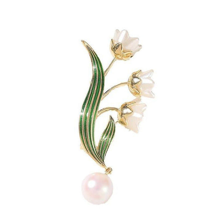 Sparkling gold-tone elegant flower brooch for women, adorned with a white pearl pendant and intricate detailing.