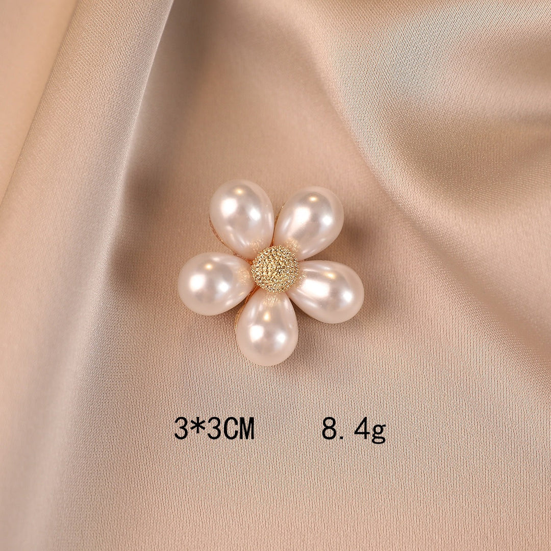 Chic floral brooch with shiny faux pearls, an elegant fashion pin that adds a statement to any outfit.