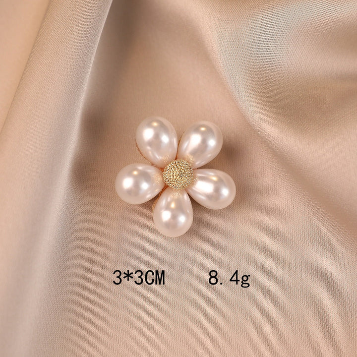 Chic floral brooch with shiny faux pearls, an elegant fashion pin that adds a statement to any outfit.