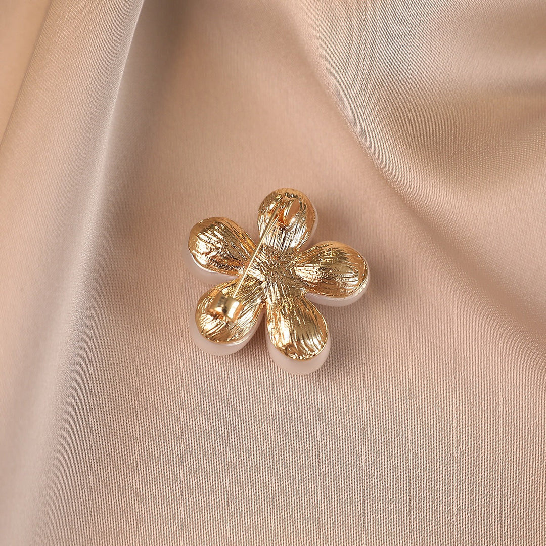 Detailed flower brooch with lustrous faux pearls, an elegant women's jewelry piece and perfect gift for her.