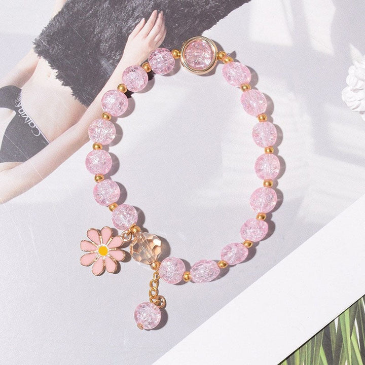 Elegant women's flower charm bracelet displayed, showcasing its beauty and sparkle.