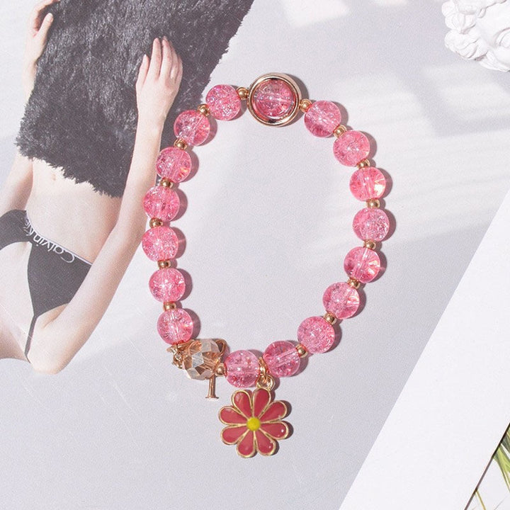 Detailed image of an elegant women's flower charm bracelet, a sparkling accessory.
