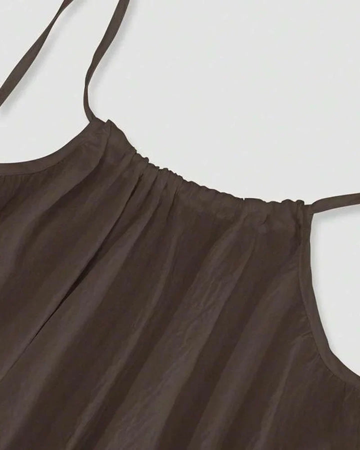 Women's flowing cami maxi dress, sleeveless, styled elegantly for summer, beach, or vacation fashion.