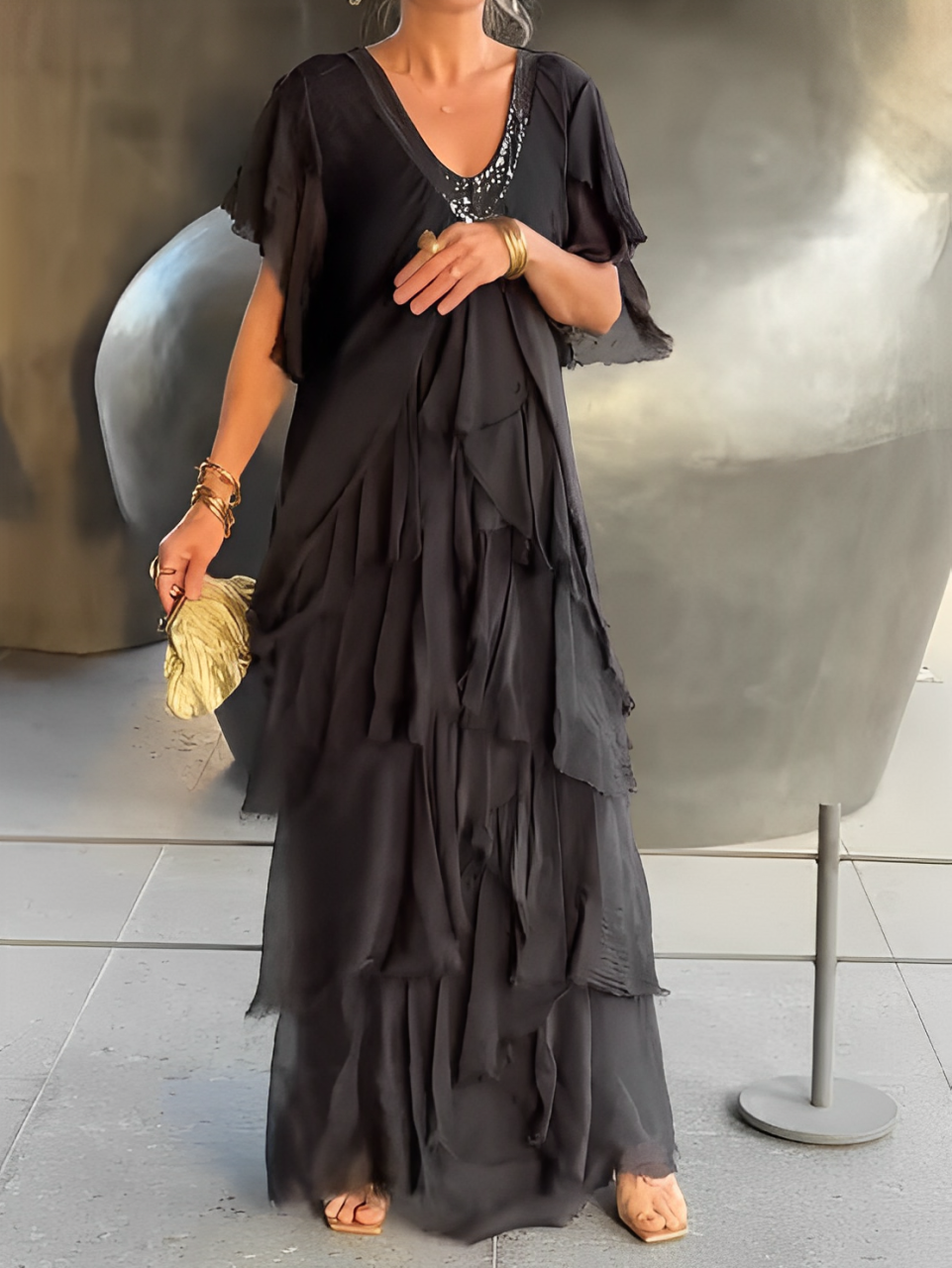 Elegant women's flowing maxi dress in chic fabric, perfect for evening or special occasion.