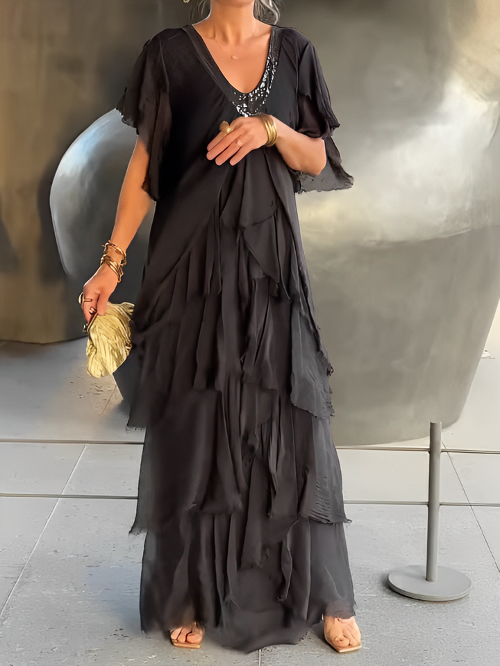 Elegant women's flowing maxi dress in chic fabric, perfect for evening or special occasion.