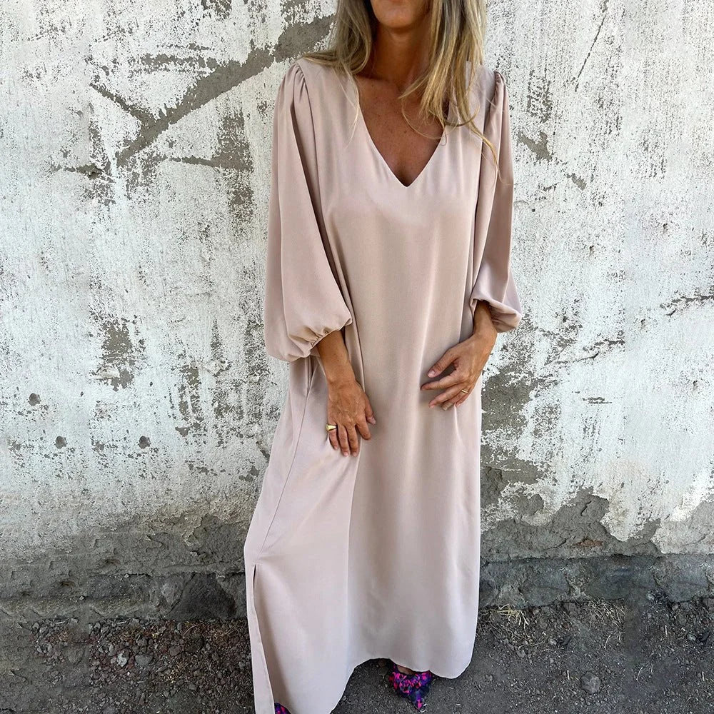 Elegant women's flowing maxi dress with V-neck, bishop sleeves, and practical pockets for day-to-night wear.